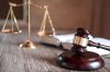 Scales of justice and Gavel on wooden table and agreement in Cou Scales of justice and Gavel on wooden table and agreement in Courtroom, Justice and Law concept.